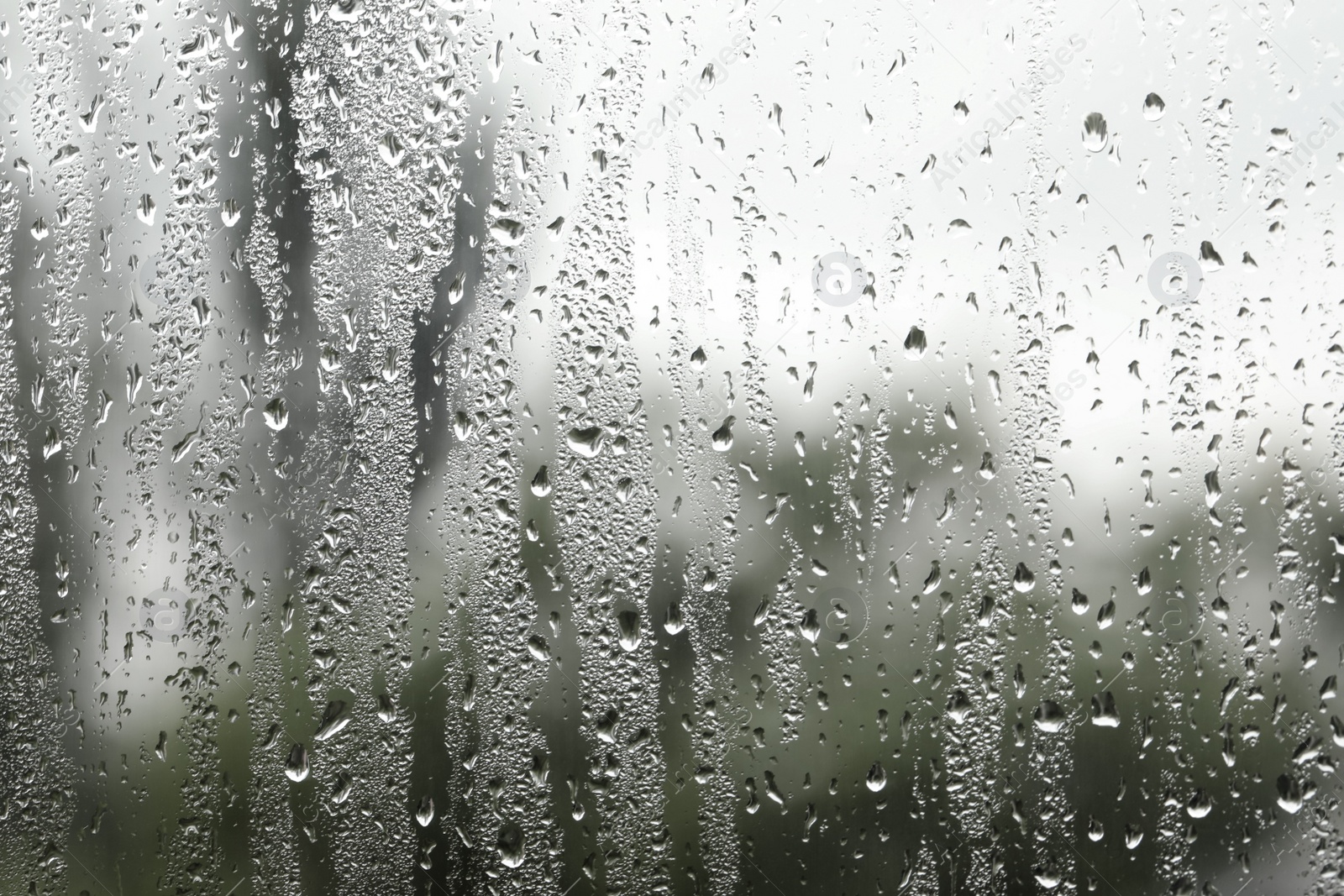 Photo of Window glass with raindrops as background, closeup