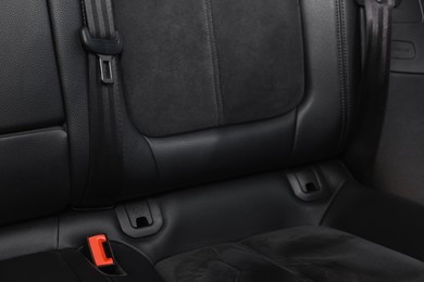 Clean leather seat inside of modern black car