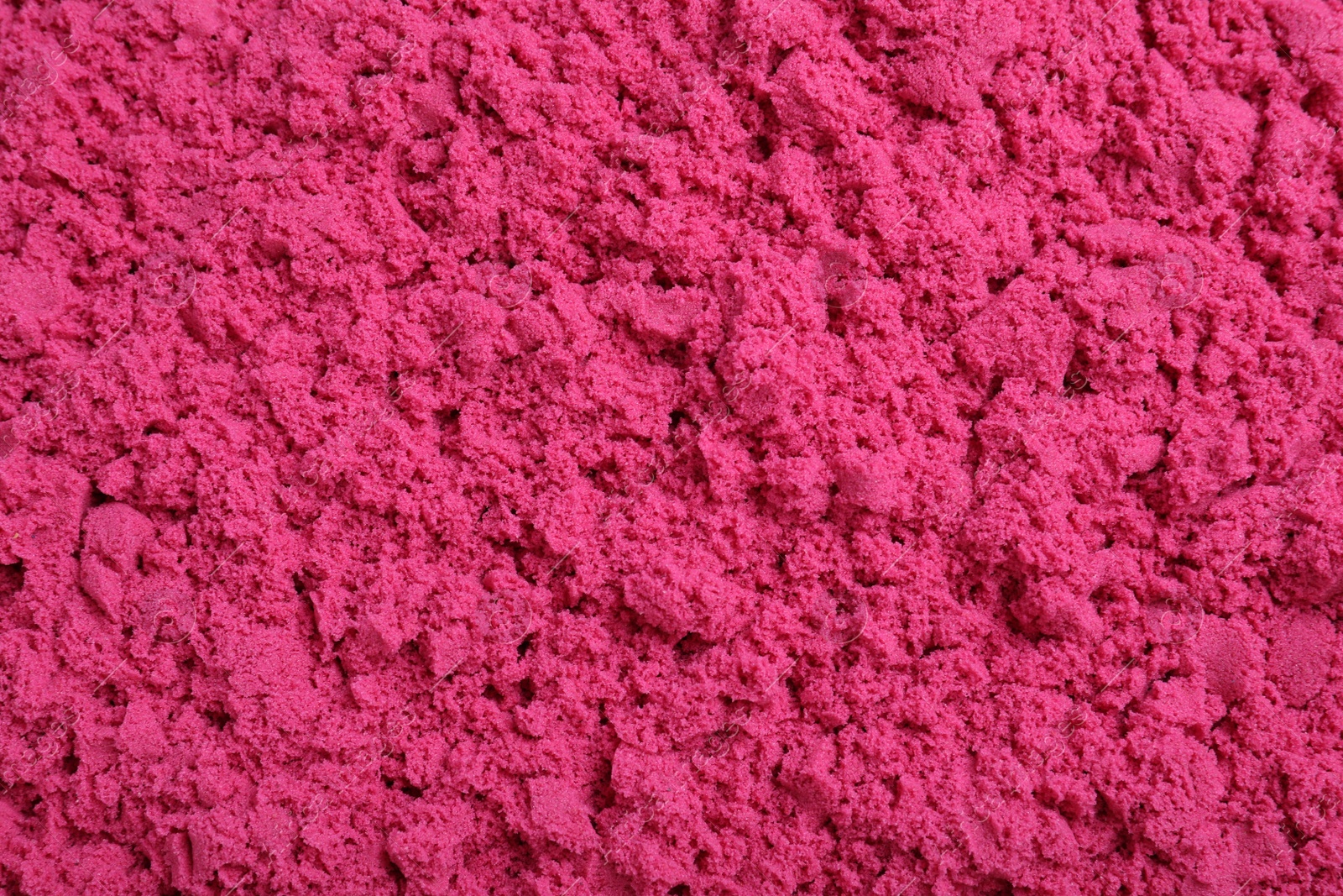 Photo of Pink kinetic sand as background, closeup view