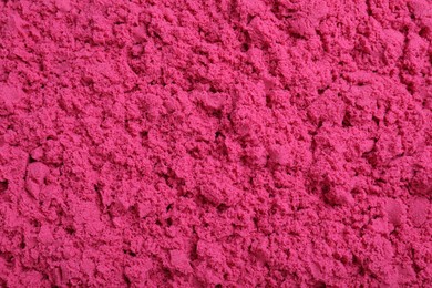 Photo of Pink kinetic sand as background, closeup view