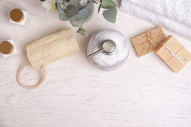 Photo of Flat lay composition with marble soap dispenser on white wooden background. Space for text