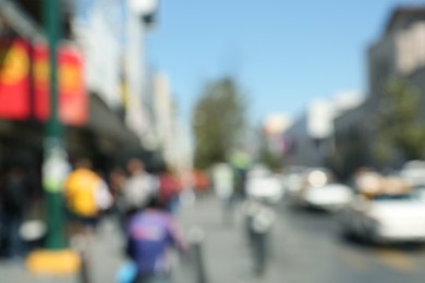 Blurred view of people on city street. Bokeh effect