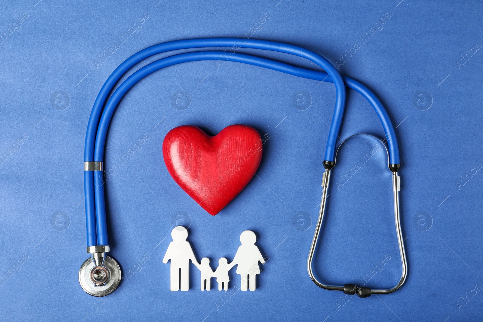 Photo of Flat lay composition with heart, stethoscope and family figure on color background. Life insurance concept