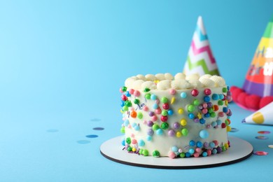 Photo of Cute bento cake with tasty cream on light blue background, space for text