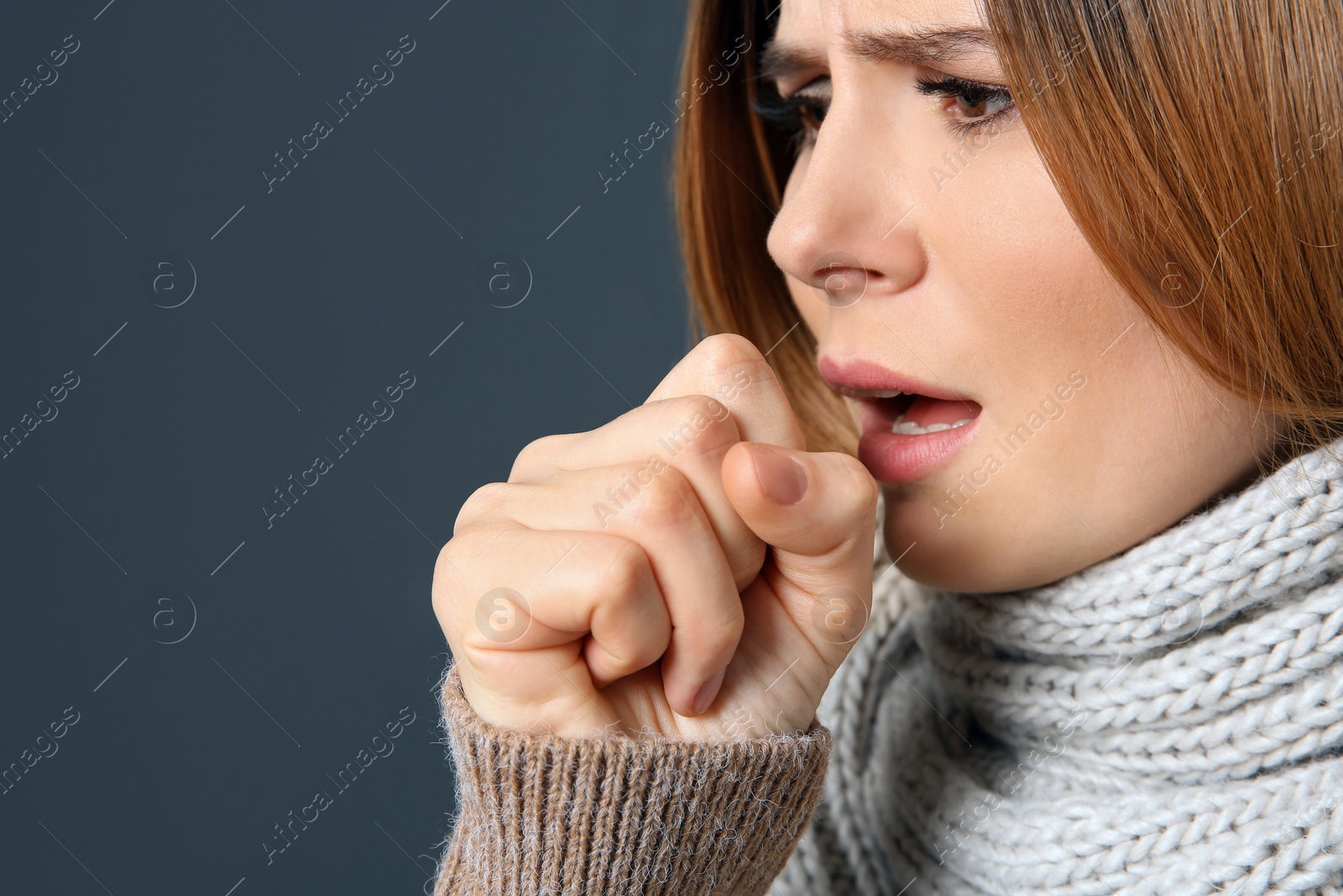 Photo of Woman suffering from cough on dark background, closeup. Space for text