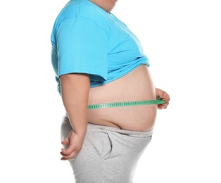Overweight man measuring waist with tape on white background, closeup