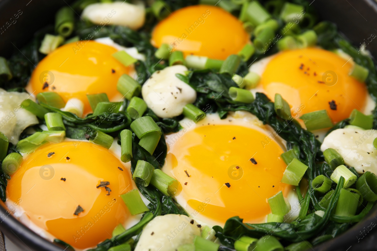 Photo of Tasty green Shakshouka in frying pan, closeup