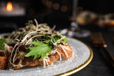 Photo of Delicious bruschettas with beef and cheese on black table, closeup