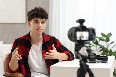 Teenage blogger explaining something while streaming at home