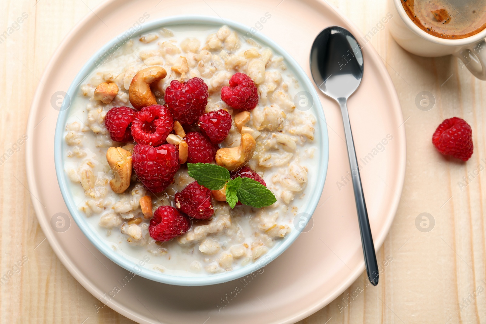 Photo of Flat lay composition with tasty oatmeal porridge on wooden table. Healthy meal