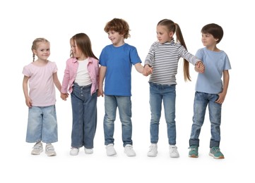 Photo of Group of cute children holding hands on white background