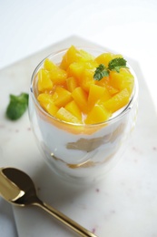 Photo of Tasty peach dessert with yogurt served on white table