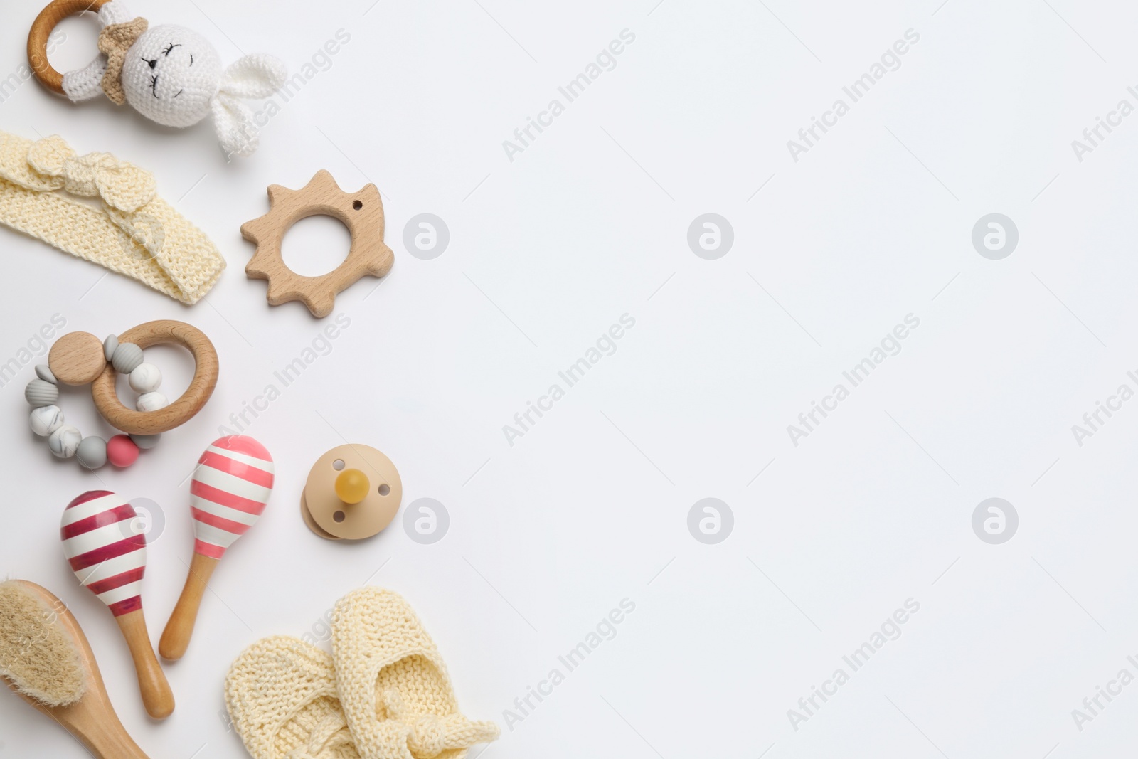 Photo of Cute baby wooden toys and accessories on white background, top view