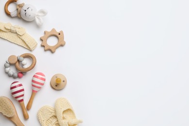 Photo of Cute baby wooden toys and accessories on white background, top view