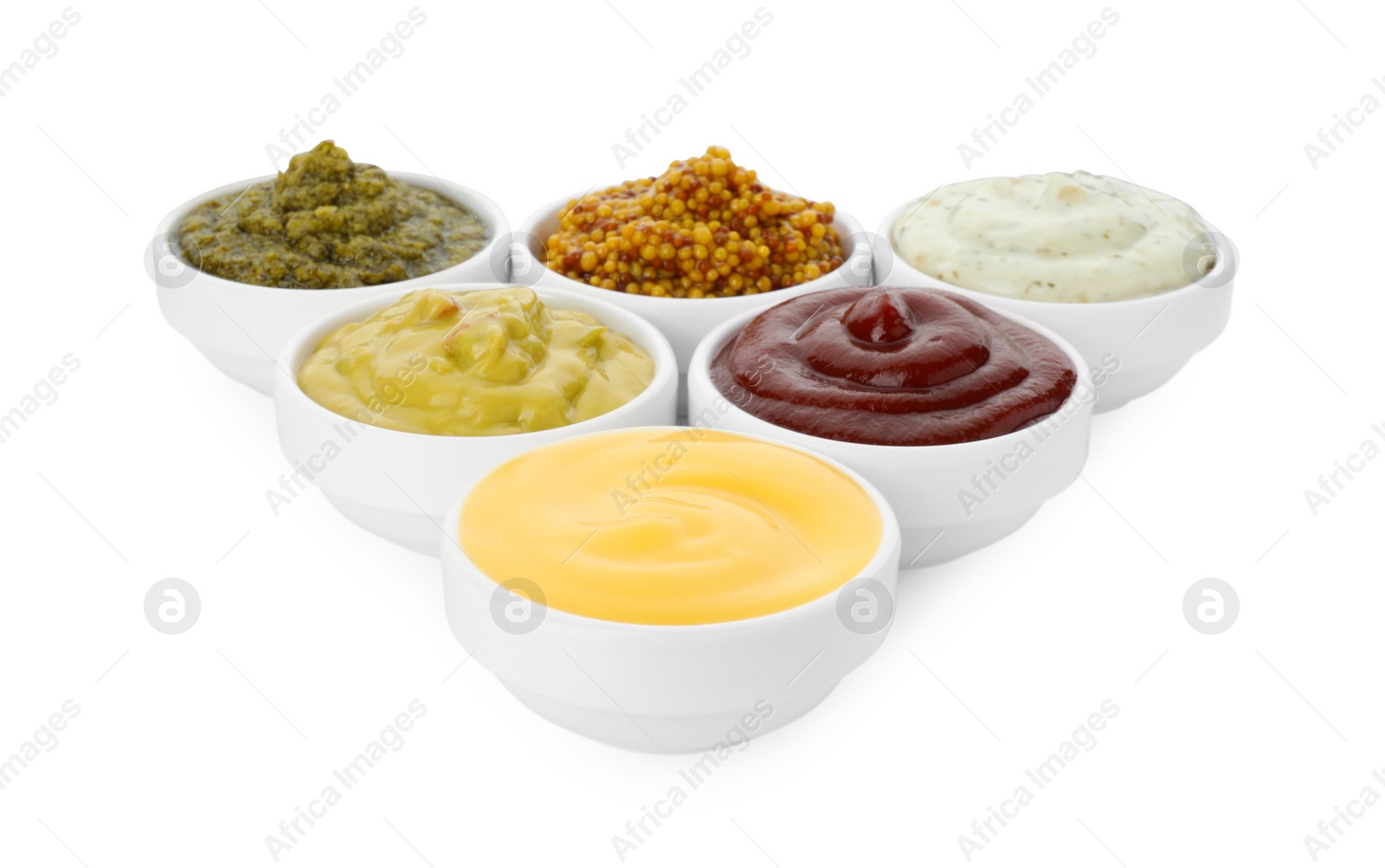 Photo of Many different sauces in bowls on white background