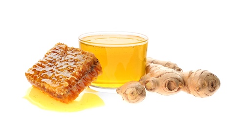 Photo of Ginger and honey on white background. Natural cold remedies