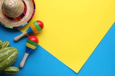 Photo of Maracas, toy cactus and sombrero hat on colorful background, flat lay with space for text. Musical instrument