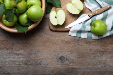 Photo of Flat lay composition with juicy green apples on wooden table, space for text
