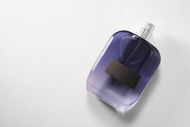 Luxury men`s perfume in bottle on white background, top view. Space for text
