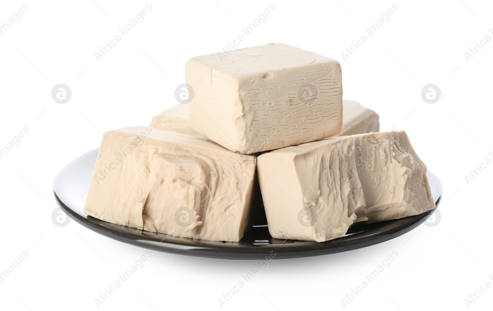 Photo of Plate with pieces of compressed yeast on white background