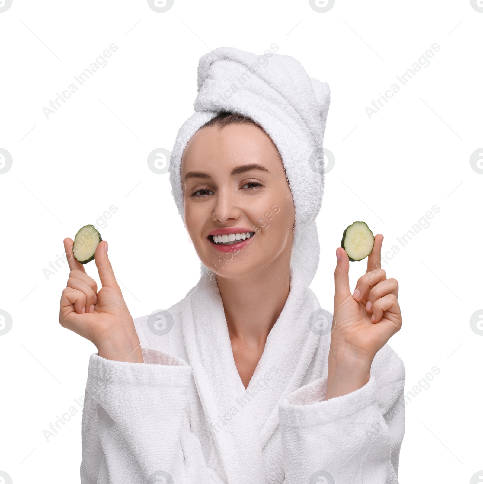 Photo of Beautiful woman in bathrobe with pieces of cucumber on white background