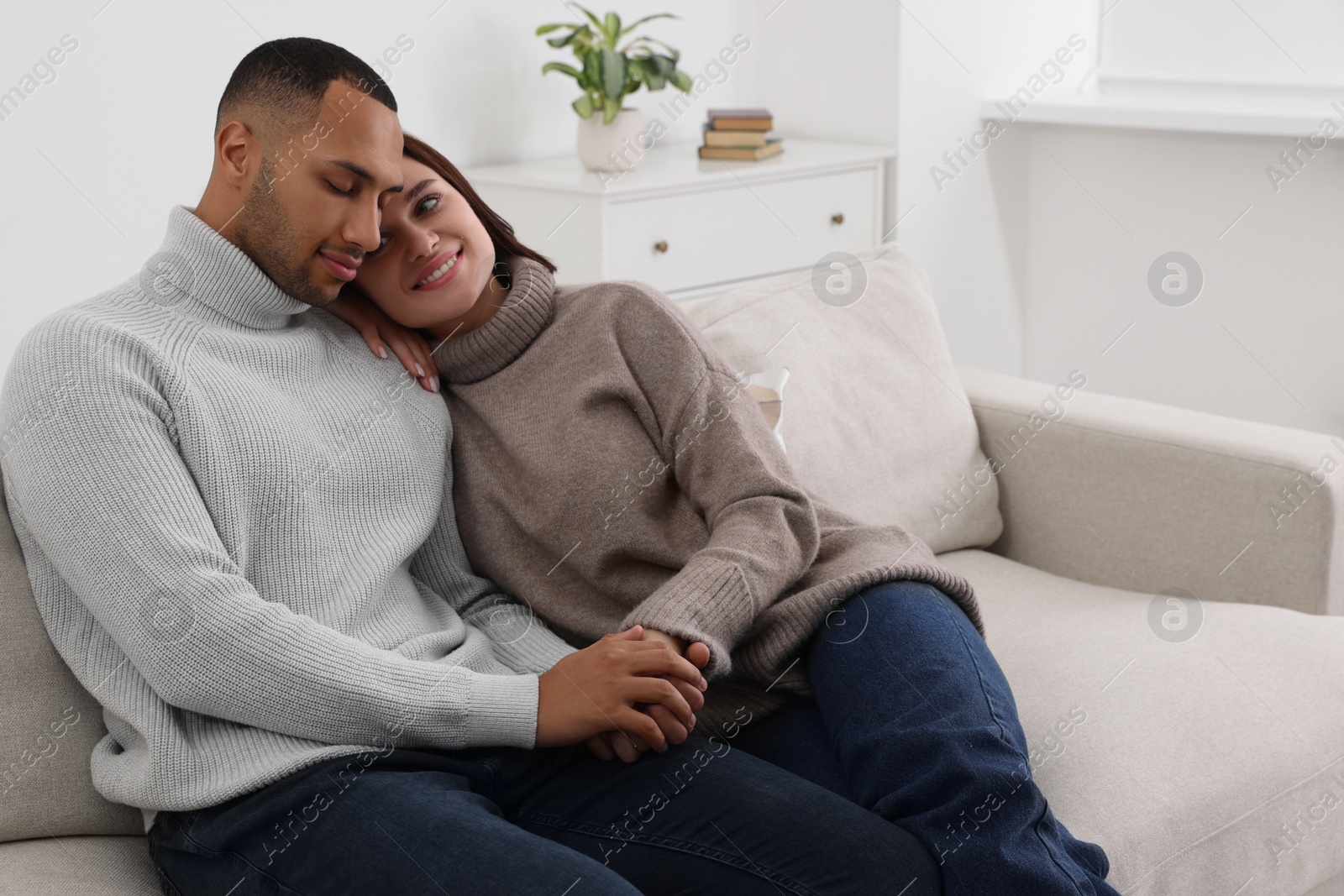 Photo of Dating agency. Happy couple spending time together on sofa at home