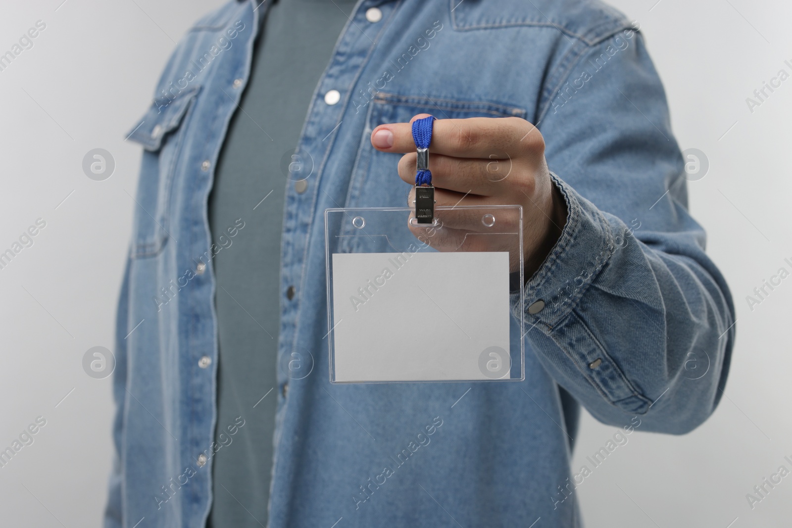 Photo of Man with blank badge on grey background, closeup