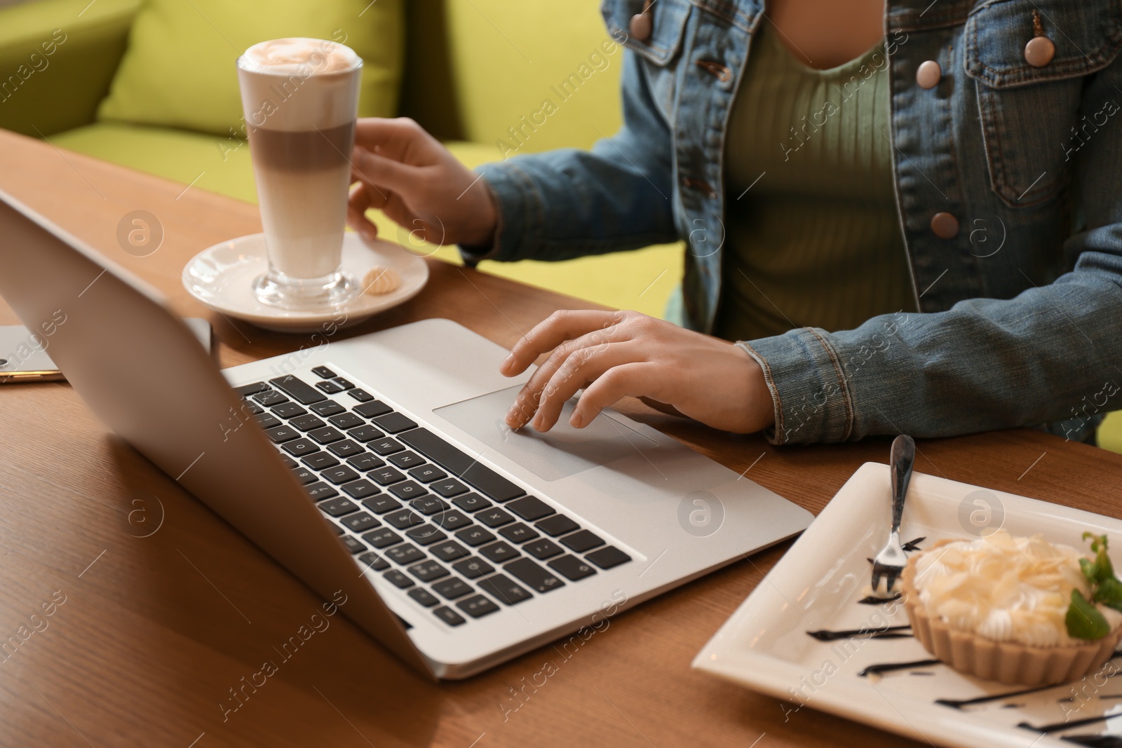 Photo of Blogger working with laptop in cafe, closeup