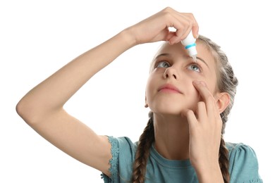 Photo of Adorable little girl using eye drops on white background