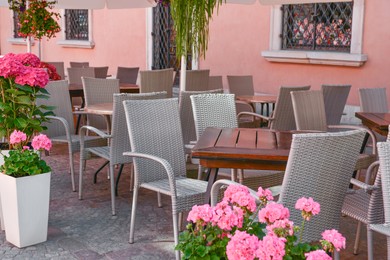Photo of Outdoor cafe with beautiful flowers and comfortable furniture