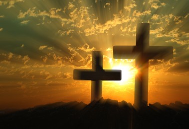 Image of Silhouette of Christian crosses outdoors at sunset