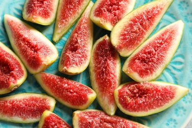 Plate with fresh ripe fig slices, top view. Tropical fruit