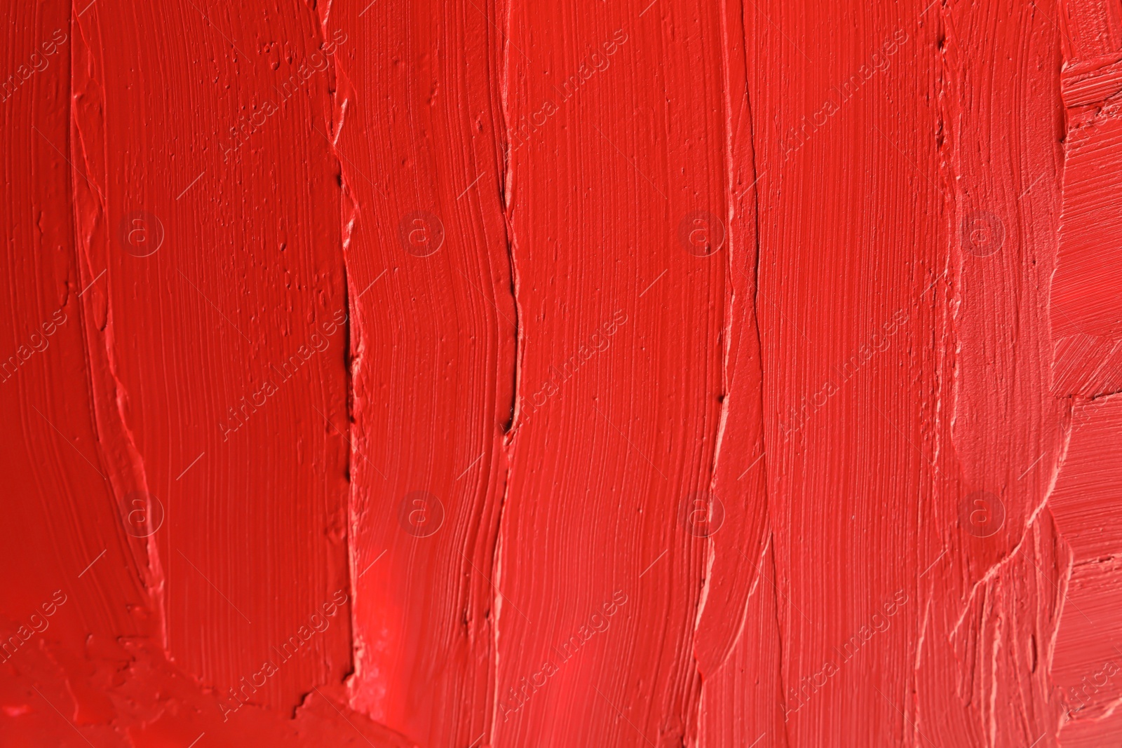 Photo of Red lipstick smears as background, closeup. Cosmetic product