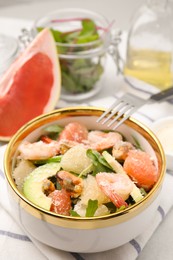 Photo of Delicious pomelo salad with shrimps served on table, closeup