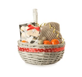 Photo of Christmas wicker gift basket with champagne and tangerines on white background