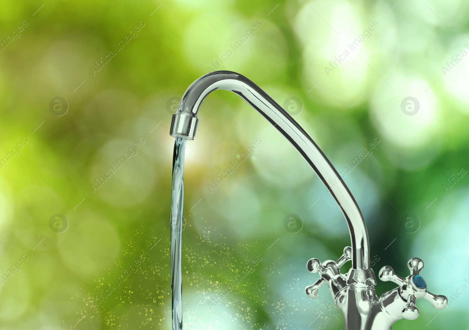 Image of Water flowing from tap outdoors on sunny day, bokeh effect