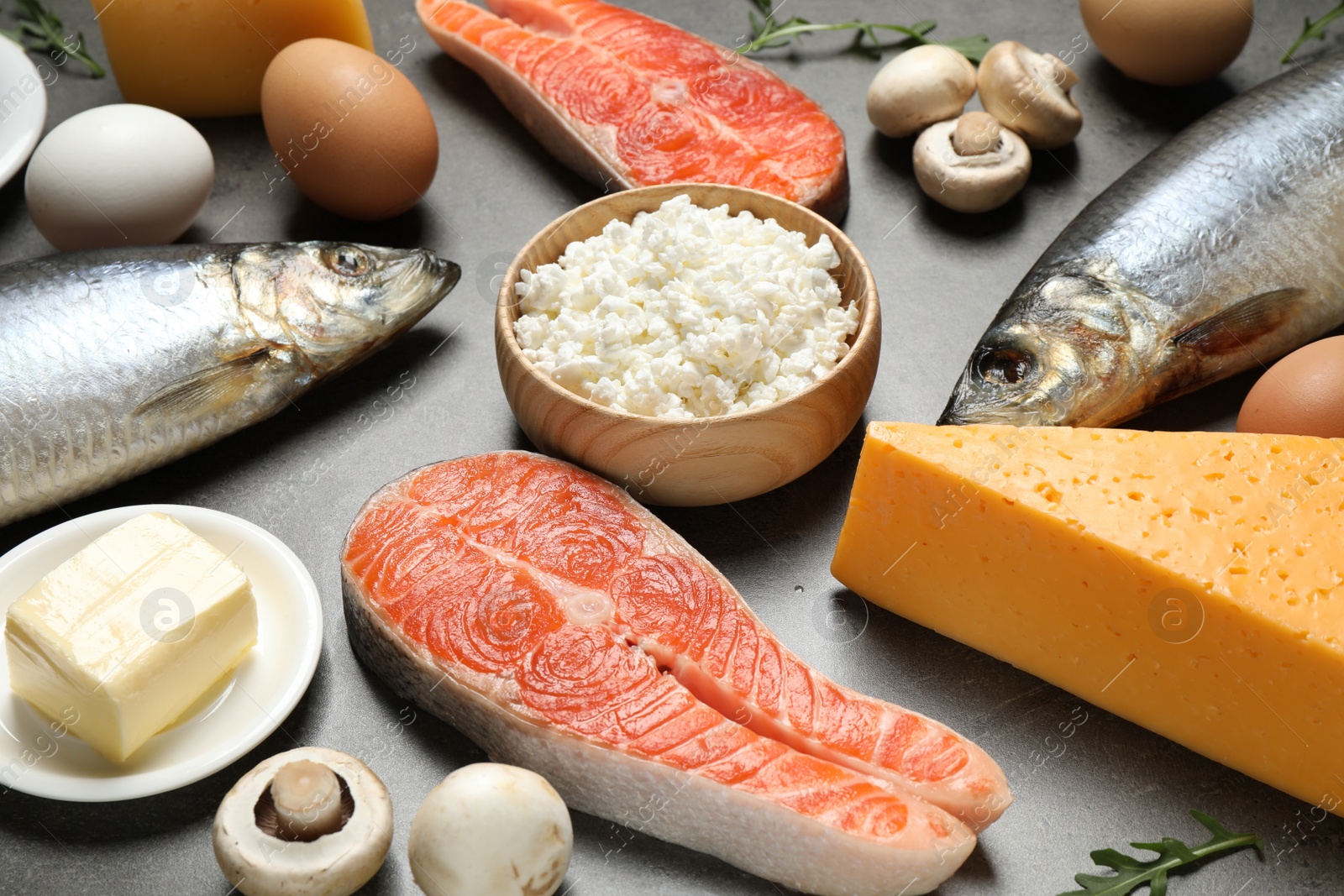 Photo of Fresh products rich in vitamin D on grey table