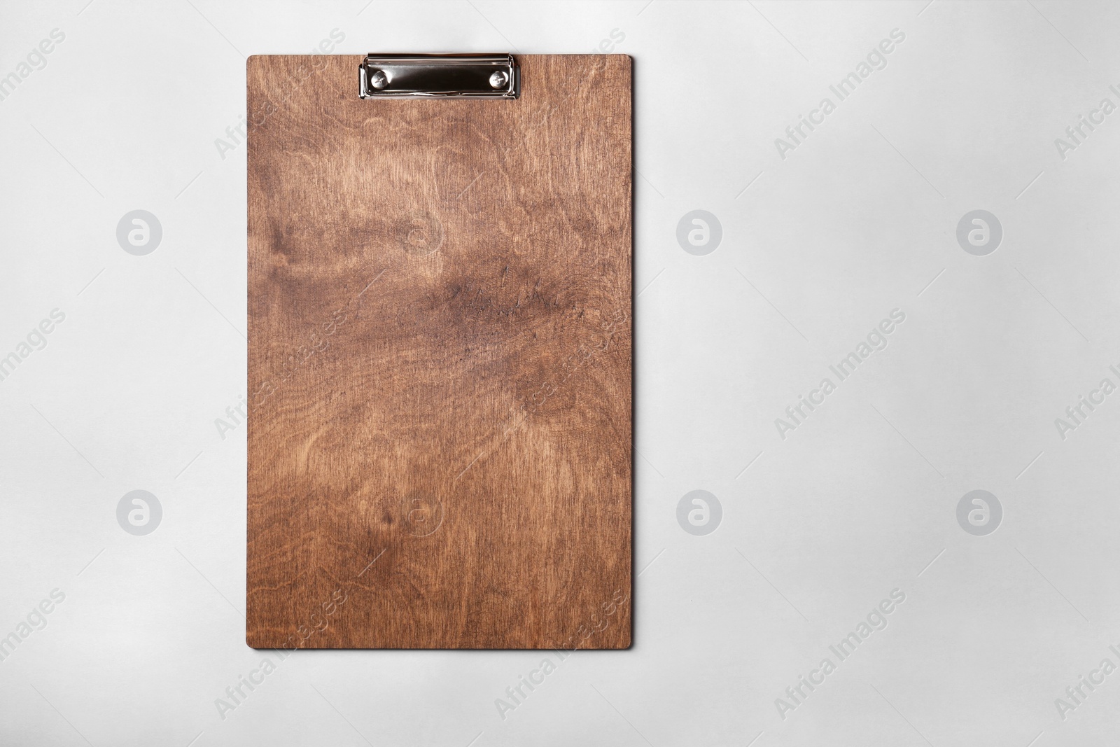 Photo of Wooden clipboard on light grey background, top view. Space for text