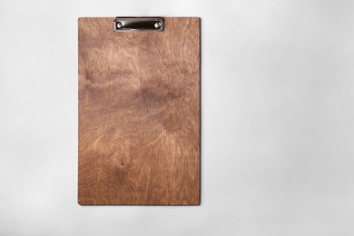 Wooden clipboard on light grey background, top view. Space for text