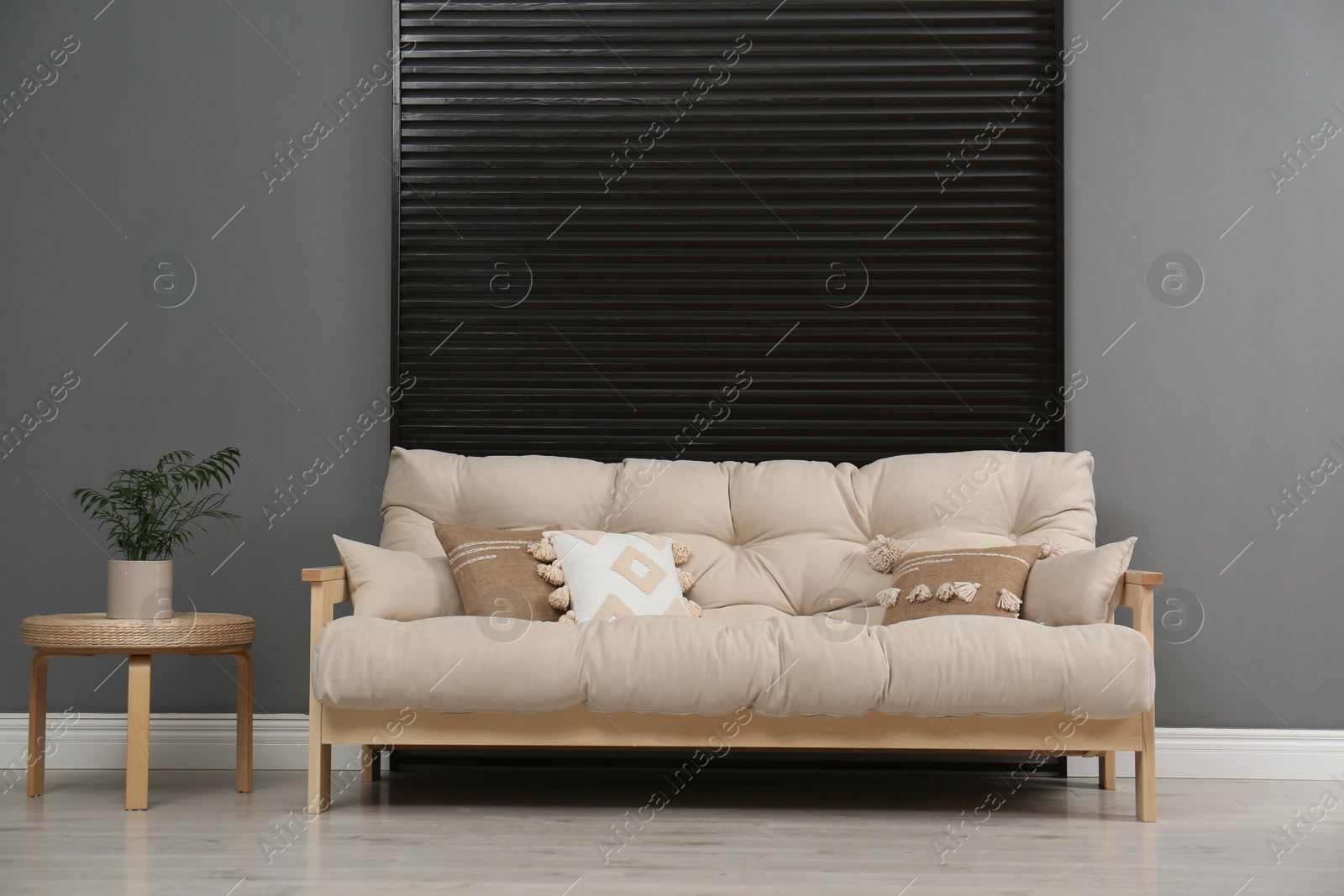 Photo of Stylish beige sofa in living room interior