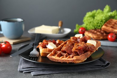 Tasty Belgian waffles served with bacon, butter and coffee on grey table, closeup