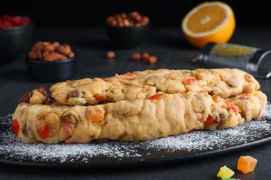 Photo of Unbaked Stollen with candied fruits and raisins on grey table, closeup