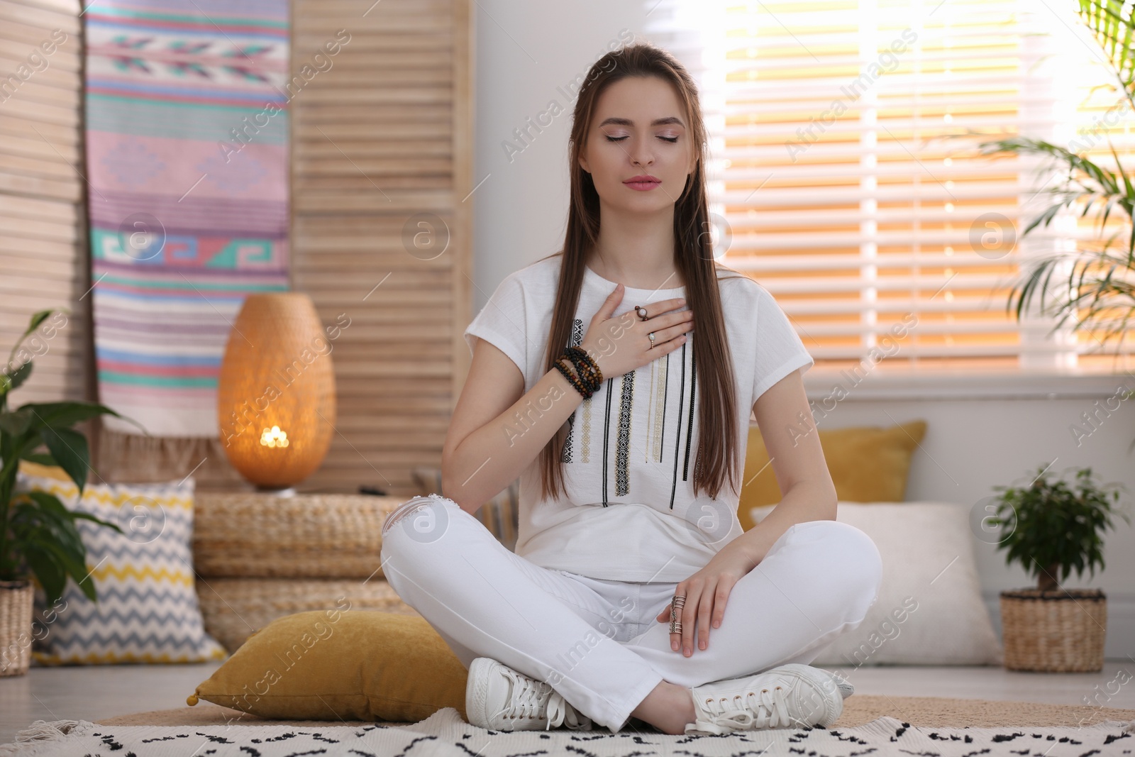 Photo of Young woman during self-healing session in therapy room