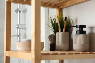 Shelving unit with toiletries in bathroom interior