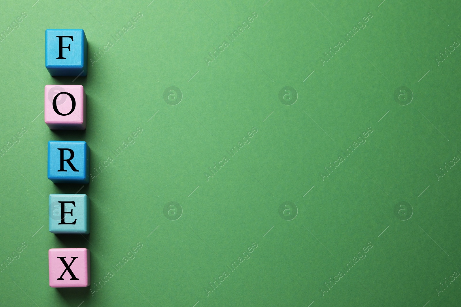 Photo of Word Forex made with colorful cubes on green background, flat lay. Space for text