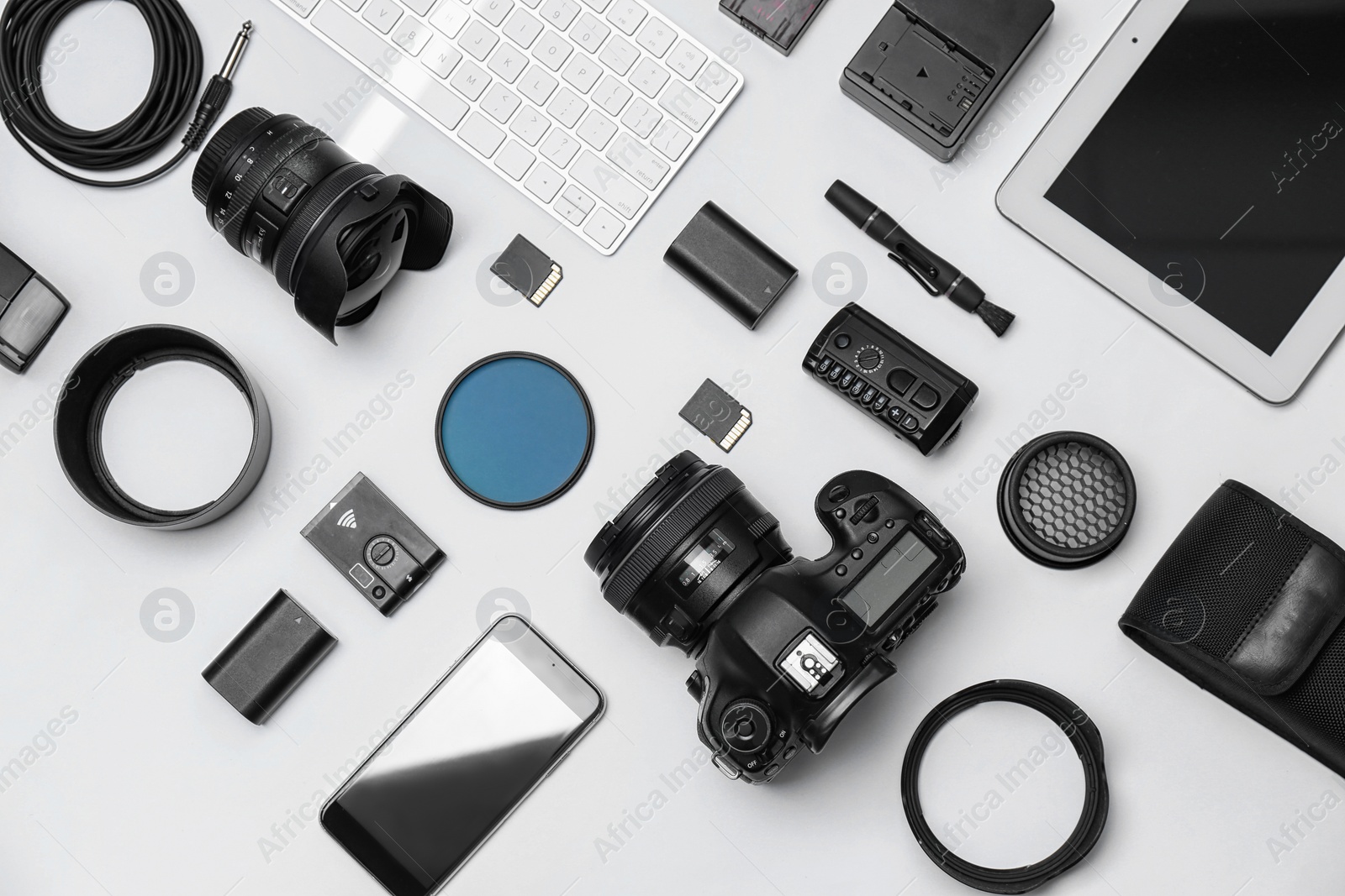 Photo of Flat lay composition with equipment for professional photographer on white background