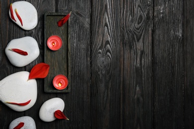 Flat lay composition with spa stones and space for text on wooden background