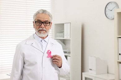 Mammologist with pink ribbon in hospital. Breast cancer awareness