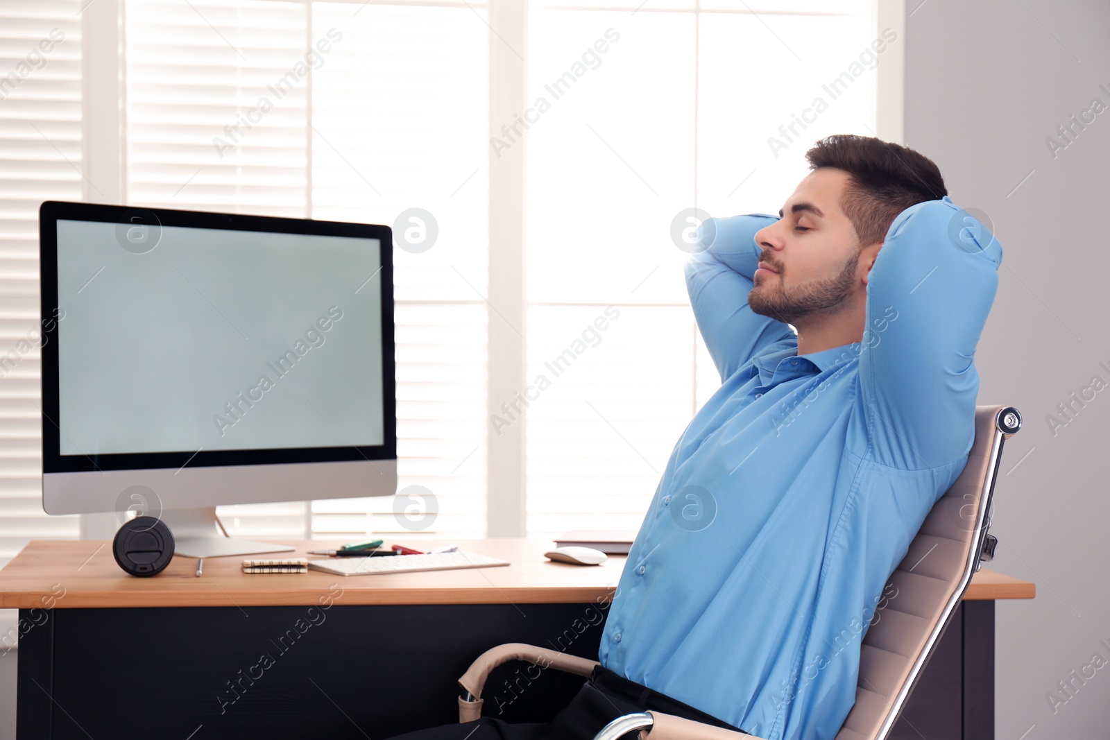 Photo of Lazy employee resting at table in office