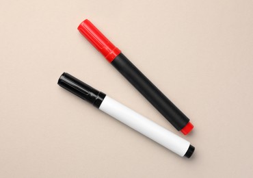 Photo of Bright color markers on beige background, flat lay